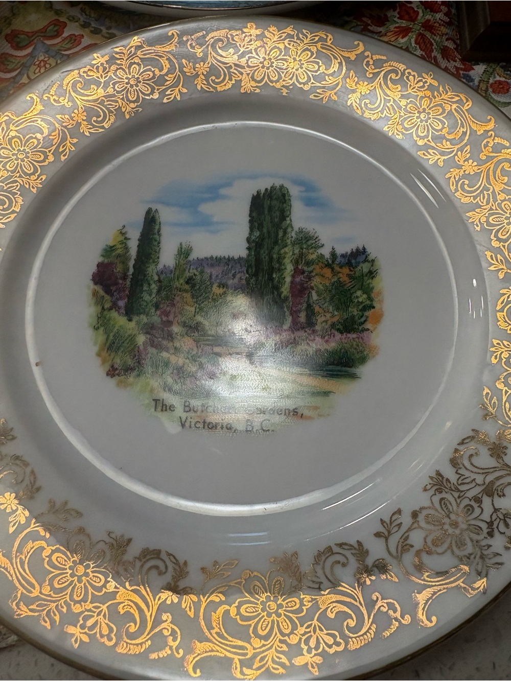 Decorative Gold-Trimmed White Collector Plate with Garden Scene